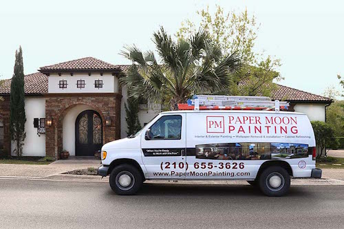 Paper Moon Painting company van in front of exterior painting project in San Antonio