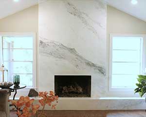 Venetian plaster fireplace imitiating Calacatta Gold marble by Paper Moon Painting