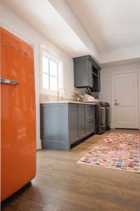 Laundry room with orange vintage fridge and painted cabinets in BM CSP-120 Burnt Ember by Paper Moon Painting, Austin cabinet painter