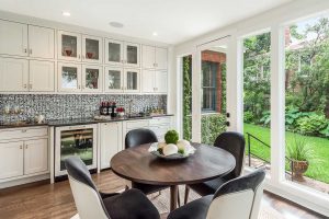 kitchen-breakfast-area-with-white-cabinets-paper-moon-painting-alamo-heights