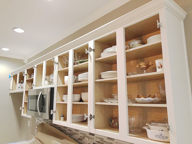 Kitchen cabinets with doors and masking removed, ready to reassemble