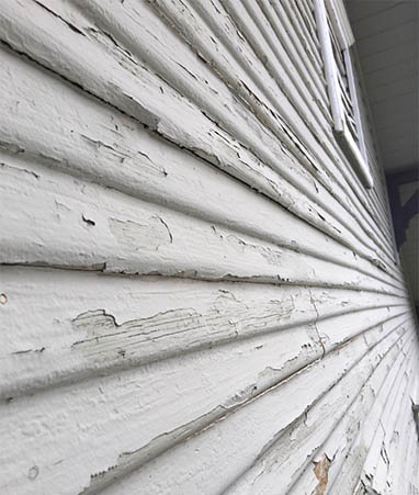 peeling-house-siding-paint-seen-up-close