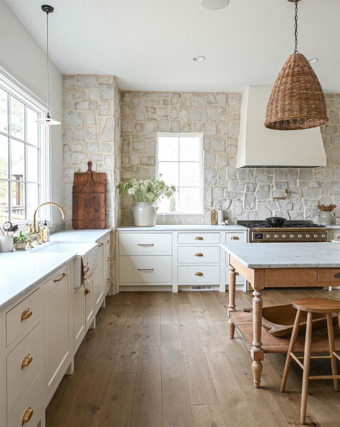 white-kitchen-with-stone-wall-and-rattan-pendants