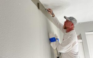 pro-painter-rolling-a-cut-line-at-ceiling-self-priming-paint